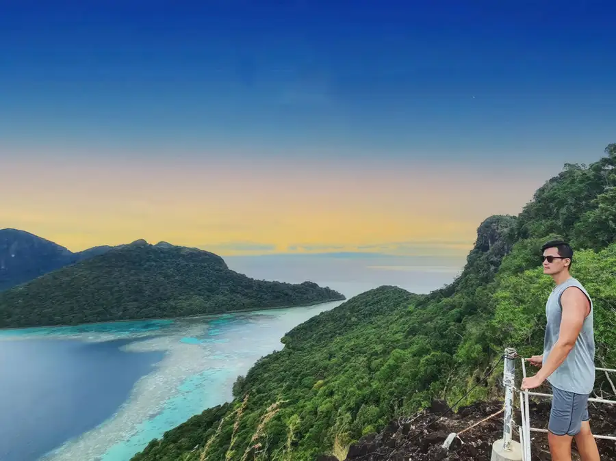 View from Bohey Dulang island summit looking down at the turquoise lagoon and surrounding islands